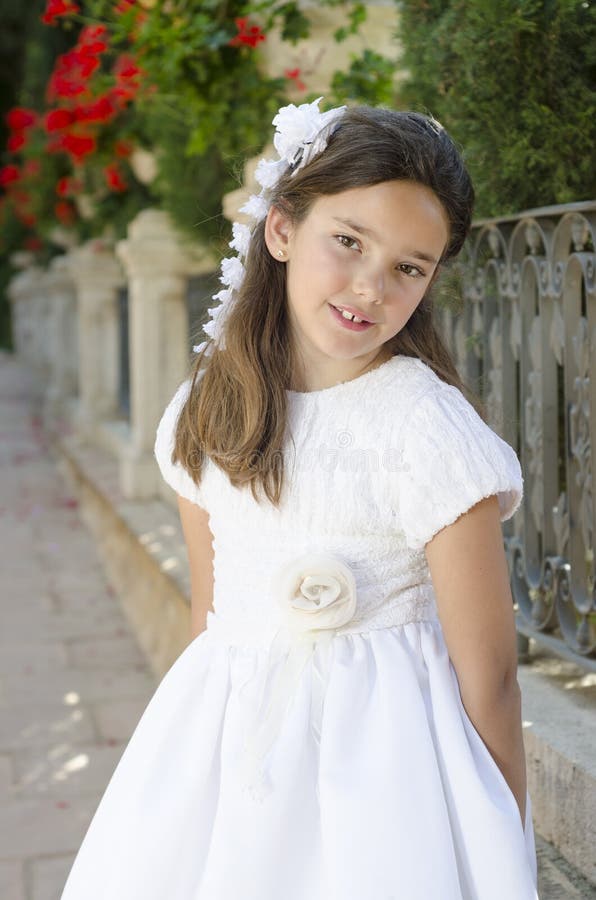 First Communion, Young Girl Wear White Dress at Exterior. Flowers at ...