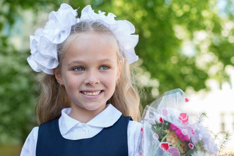 A First-grader Girl in a Beautiful Elegant Modern School Uniform on the ...