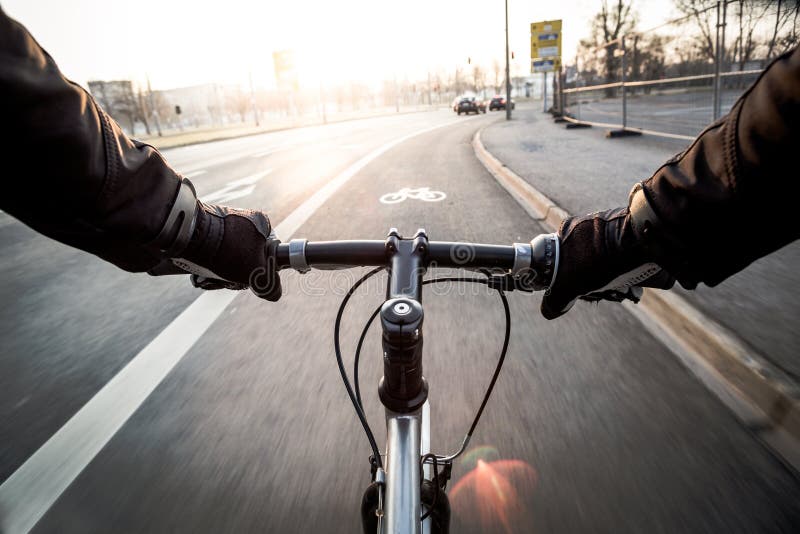 First-person view of cyclist in the city at morning royalty free stock photography