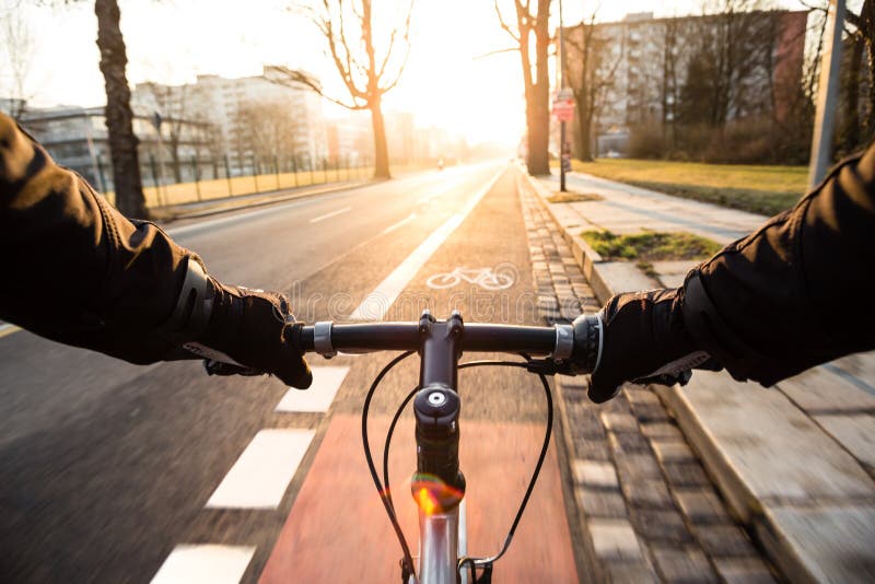 First-person view of cyclist in the city at morning stock photography