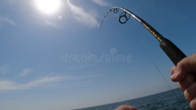 https://thumbs.dreamstime.com/b/first-person-view-man-s-hands-reeling-heavy-fish-spinning-reel-stock-k-footage-268656736.jpg?w=400