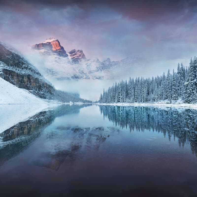 First snow Morning at Moraine Lake in Banff National Park Alberta Canada. Snow-covered winter mountain lake in a winter atmosphere. Beautiful background photo royalty free stock images