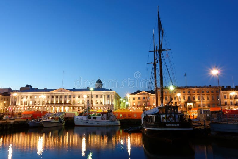 Fishing boats and an old sailing boat at the Helsinki Market Square (Kauppatori in Finnish) with market tents on the background during the annual Helsinki Baltic Herring Fair (Silakkamarkkinat in Finnish) on clear early October evening. The Baltic Herring Fair has been organized in Helsinki every year in the beginning of October at the Market Square without breaks since year 1743. Fishing boats and an old sailing boat at the Helsinki Market Square (Kauppatori in Finnish) with market tents on the background during the annual Helsinki Baltic Herring Fair (Silakkamarkkinat in Finnish) on clear early October evening. The Baltic Herring Fair has been organized in Helsinki every year in the beginning of October at the Market Square without breaks since year 1743.