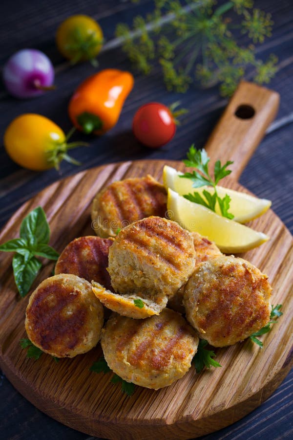 Fish Cakes with Lemon and Herbs. Fish Patties on Wooden Board. Stock