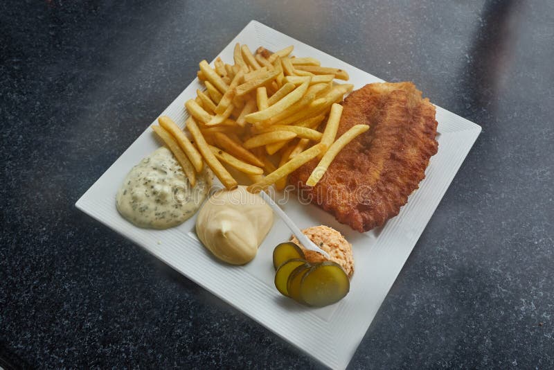 Fish and Chips served with sauces and salmon salad