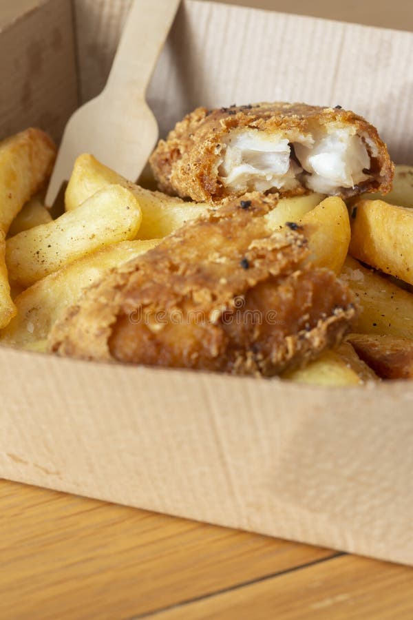Fish and Chips Takeaway in a Cardboard Tray with a Wooden Fork