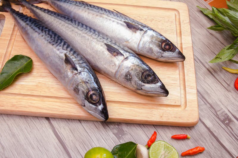 Fish on cutting board stock image. Image of lime, grass