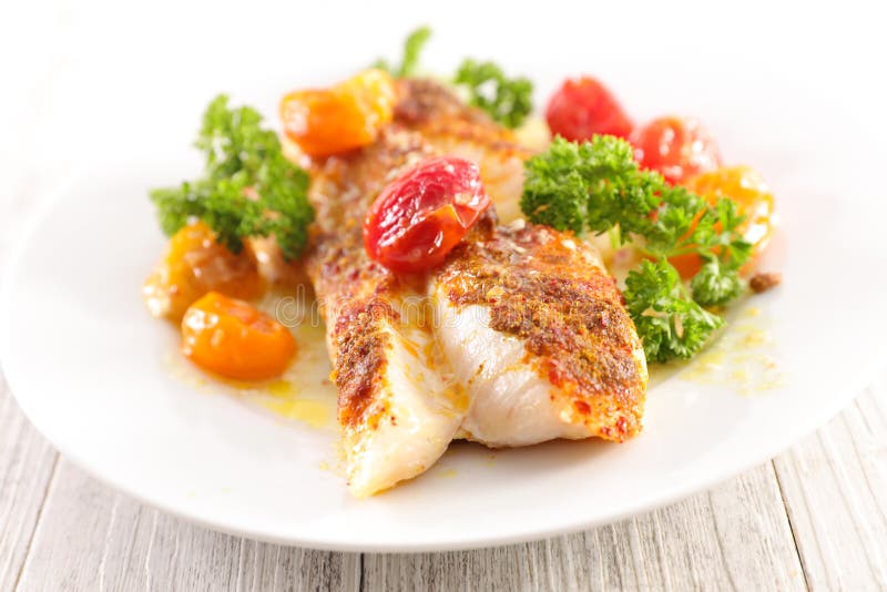 Fish fillet and tomatoes stock image. Image of meal - 137589079