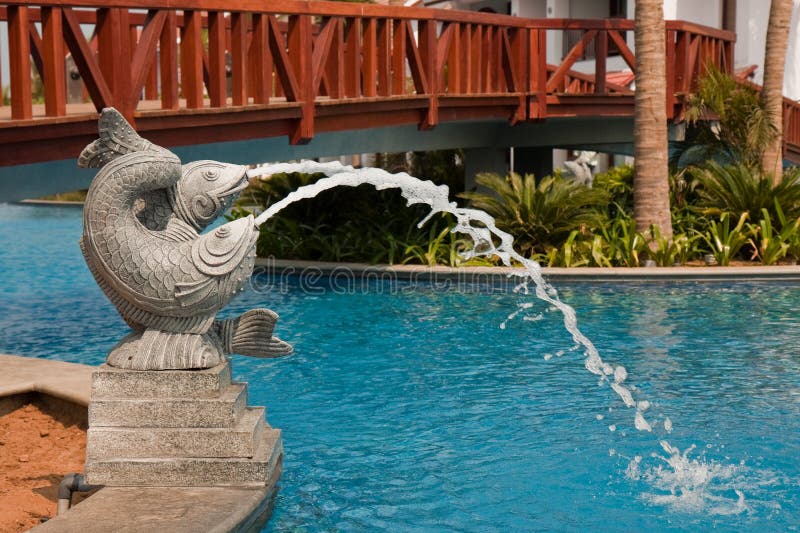 Fish Fountain under a Wooden Bridge