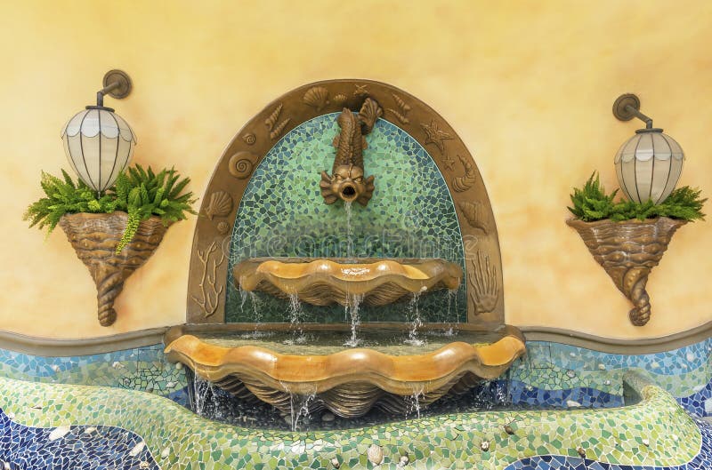 Fish fountain on wall stock photo. Image of tropical 124655060