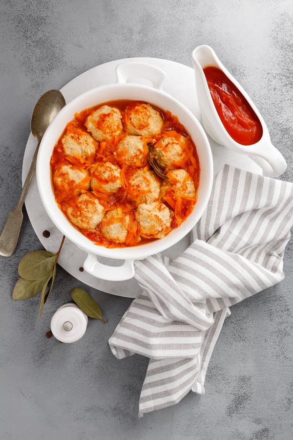 Fish Meatballs or Noisettes Baked with Carrot, Onion and Tomato Sauce