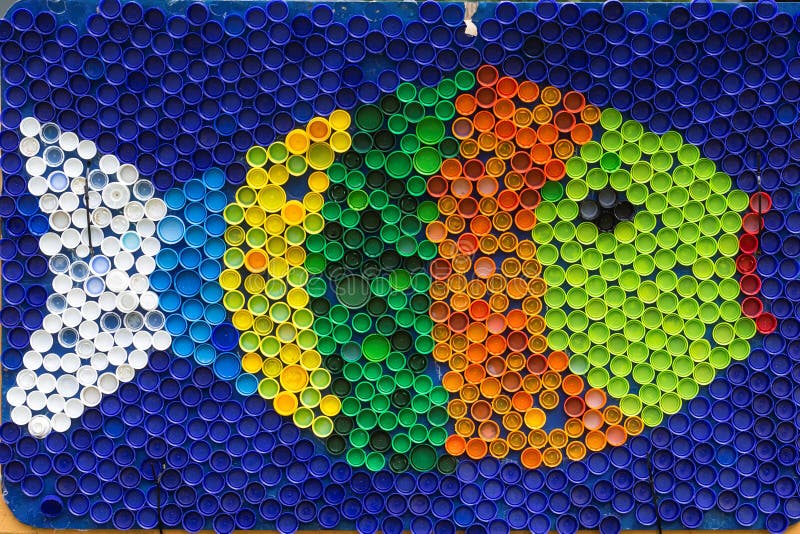 Fish mosaic deocoration made of cororful plastic bottle caps . S royalty free stock images Fish mosaic deocoration made of cororful plastic bottle caps . S royalty free stock images