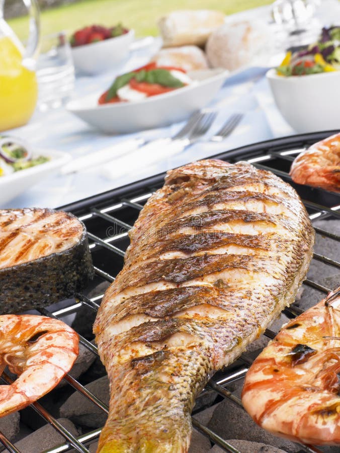 Fish And Prawns Cooking On A Grill royalty free stock photos Fish And Prawns Cooking On A Grill royalty free stock photos