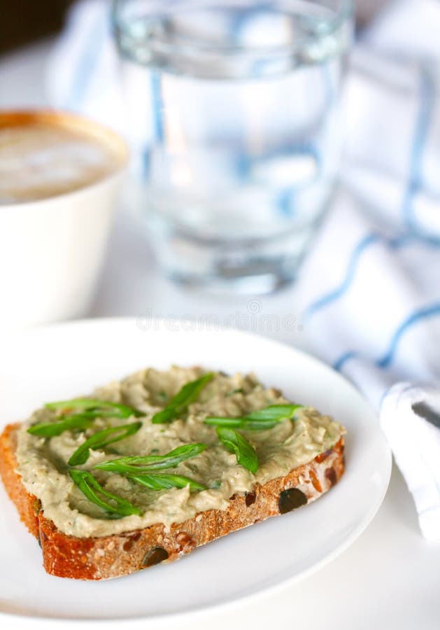 Fish pâté with scallions on whole grain bread