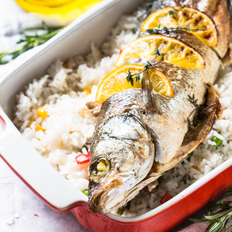 Fish Seabass Baked with Rice and Vegetables. Stock Photo - Image of