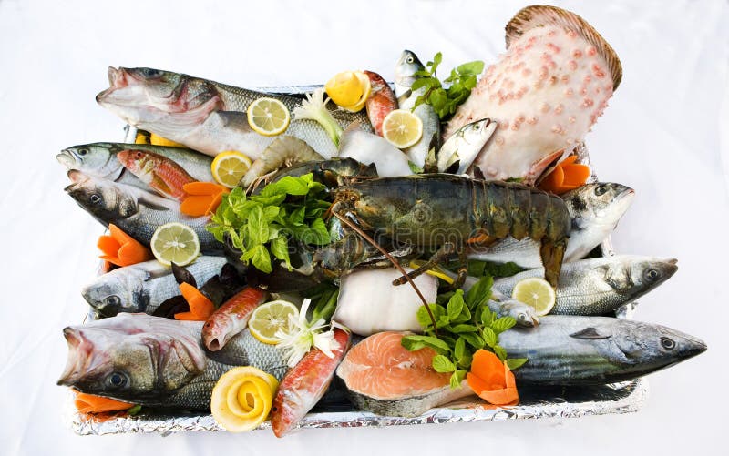 Plate full of raw fish and seafood with vegetables