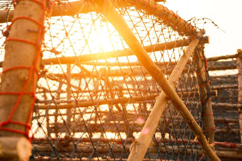 Big Fish Trap on the Quay Near the Sea with Sunset Stock Photo Image