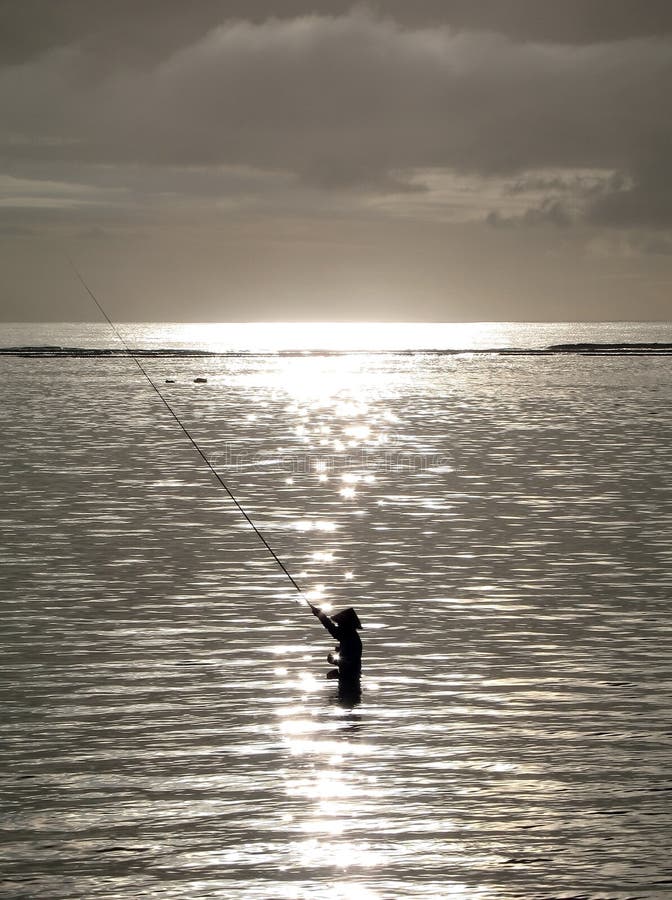 Fishing in the early morning light. Serene beach atmosphere stock images, royalty-free photos and pictures