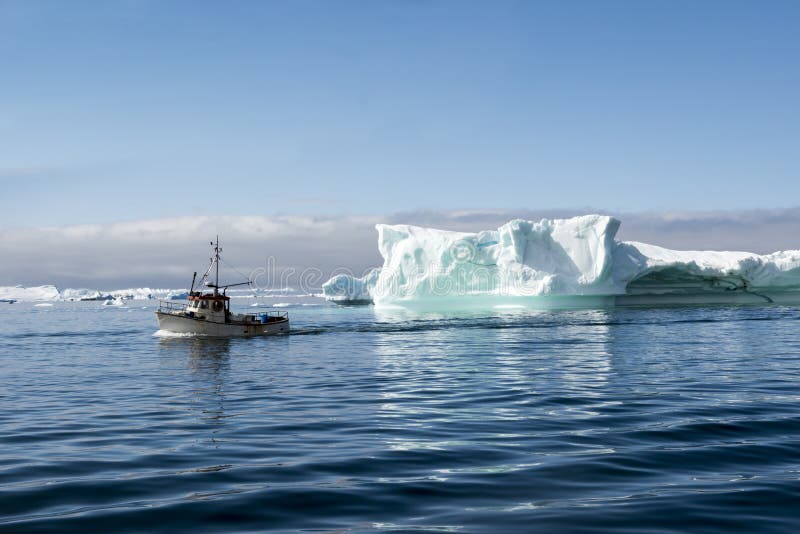 Fisherman boat between Icebergs, Disko Bay, Greenland