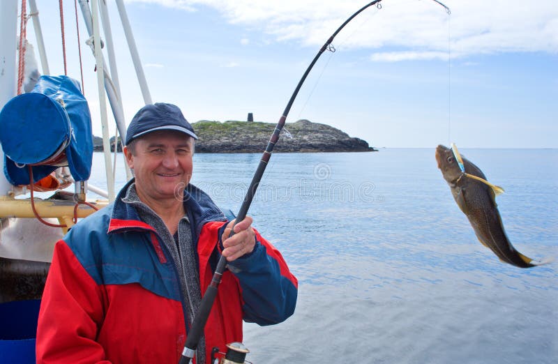 The fisherman on the boat in Norwegian fjord