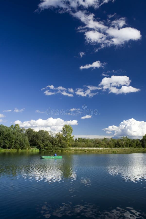 Fisherman in boat. River Drava