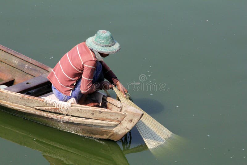 Fisherman Bringing His Net into the Boat Editorial Stock Image Image