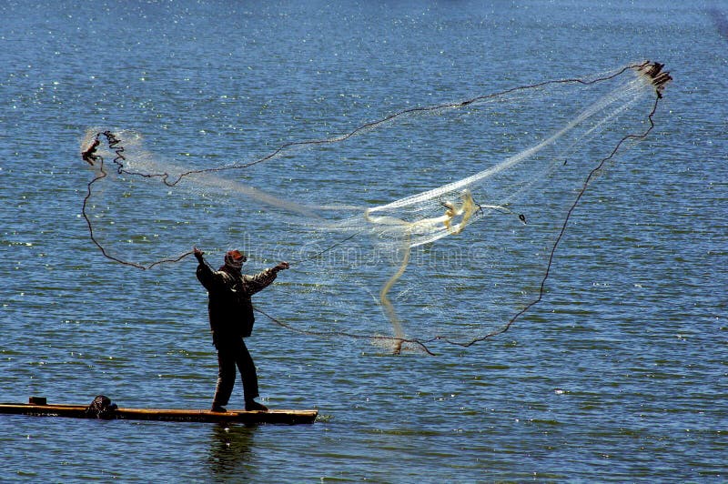 Fisherman Cast Net Fishing In Indonesia Stock Image 