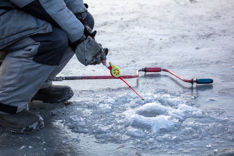 A Fisherman Catches Fish on the Ice of the Lake Stock Photo Image of