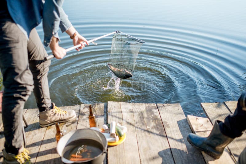 Fisherman catching fish stock image. Image of summer - 121186877