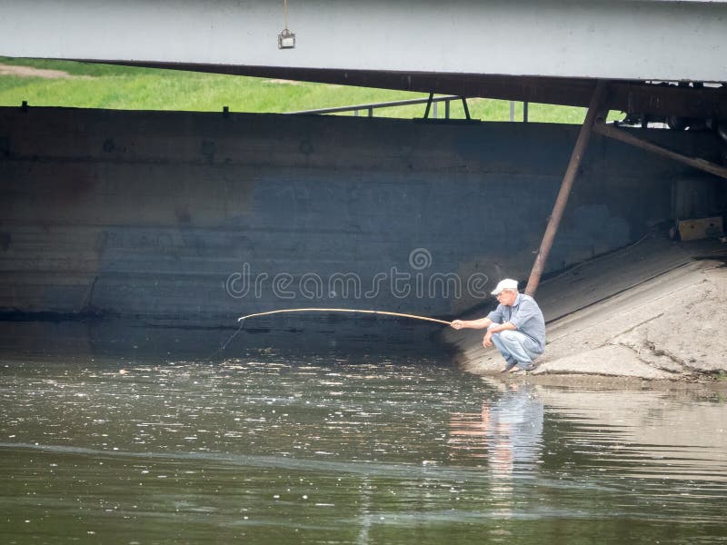 Fisherman on Embankment on a Tributary of Volga River with a Primitive  Fishing Rod Made of Tree Branch Editorial Stock Photo - Image of fishing,  landscape: 198115053