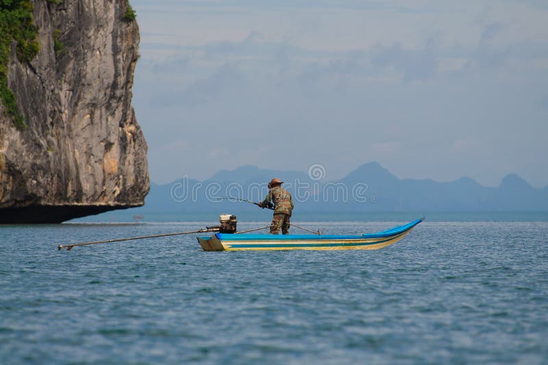 Blue sea offshore fishing boat with fisherman holding rod in action. Blue sea offshore fishing boat with fisherman holding rod in action