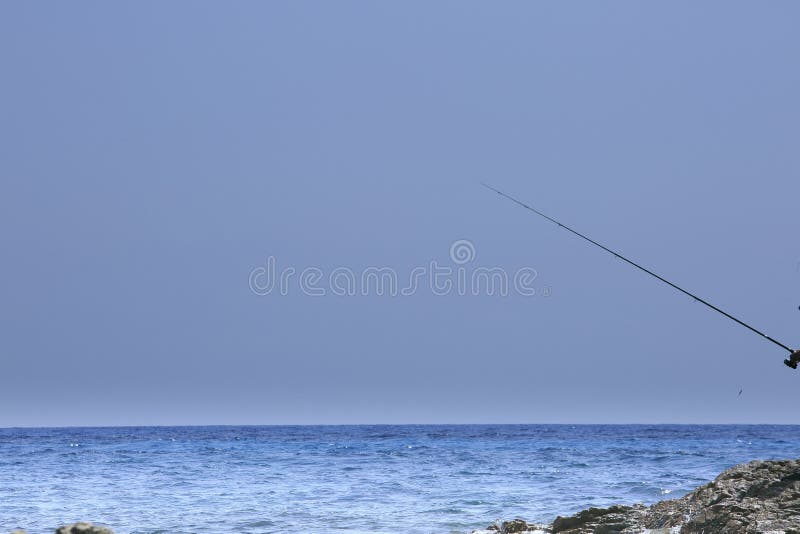 Fisherman fishing on the coast of Sardinia