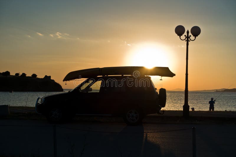 Fisherman and his car at sunset at Toroni beach, Sithonia