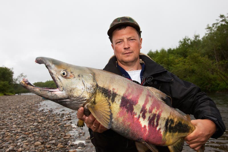 Fisherman holding a fresh caught fish