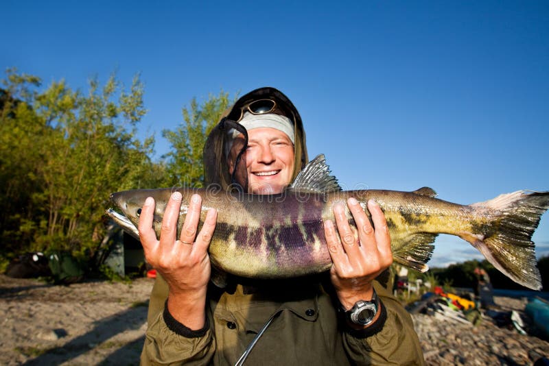 Fisherman holding a fresh caught fish