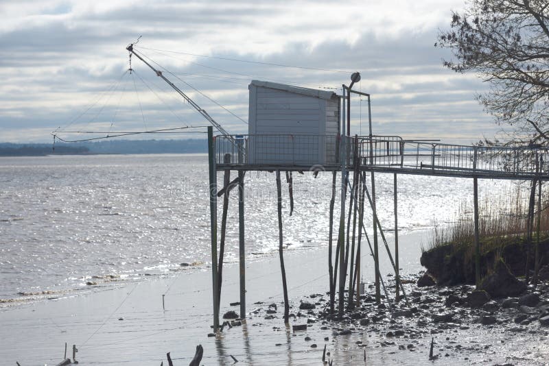 Fisherman house and net on river