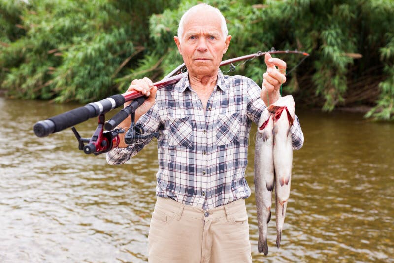 Fisherman Posing with Catch at Riverside Stock Image Image of smiling