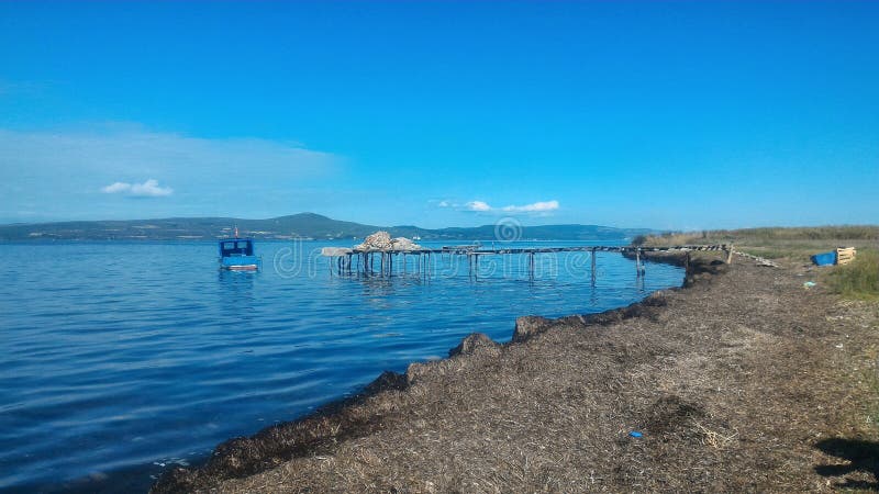 Fisherman`s Wharf and small boat in Canakkale Strait. Fisherman`s Wharf and small boat in Canakkale Strait