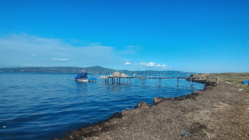 Fisherman`s Wharf and small boat in Canakkale Strait. Fisherman`s Wharf and small boat in Canakkale Strait