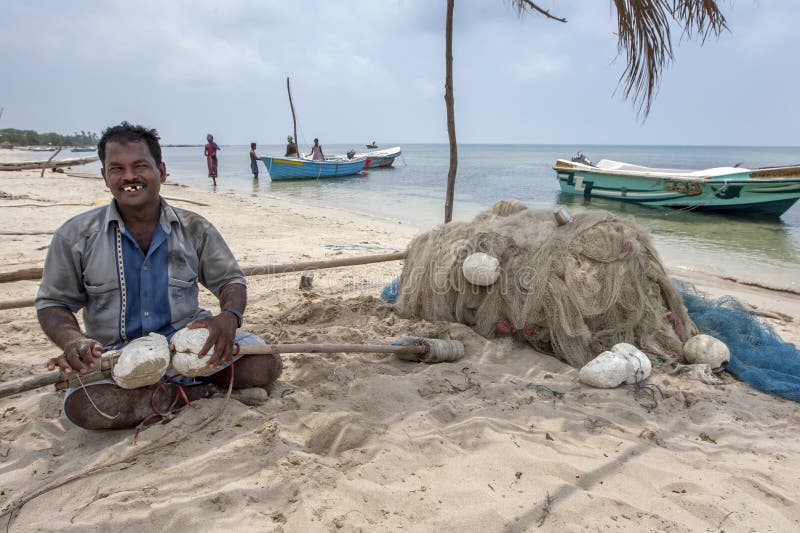 A fisherman tends to his nets on the west coast beach on Delft Island in the Jaffna region of Sri Lanka.