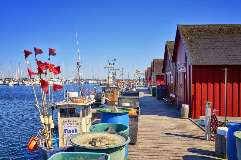 Fisherman&x27;s houses and fishing boats in the harbor. White Wiek. Letters to Boltenhagen Fischereihafen means fishing port