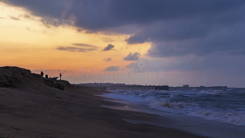 Fishermen catch fish on the seashore at sunset royalty free stock photos Fishermen catch fish on the seashore at sunset royalty free stock photos