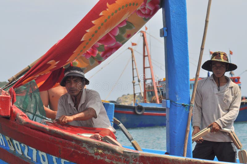 VUNG TAU, VIETNAM - MARCH 15, 2012: Fishermen on a fishing boat are ready to go offshore for a better source of fishes