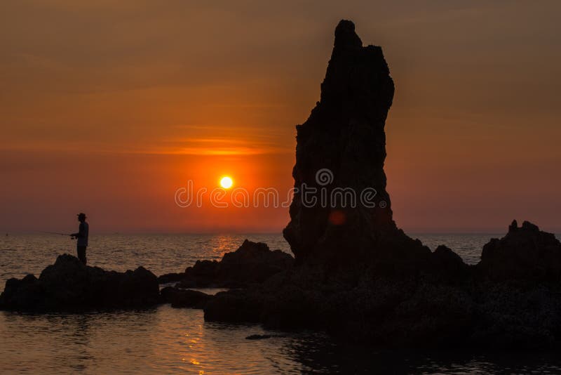 Fishermen standing on the rocks royalty free stock image Fishermen standing on the rocks royalty free stock image