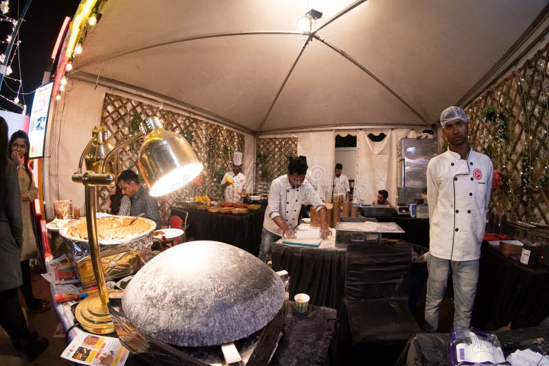 Fisheye shot of restaurant kitchen kiosk with chefs making roti nan bread with ulta tawa and gravy being prepared royalty free stock photography Fisheye shot of restaurant kitchen kiosk with chefs making roti nan bread with ulta tawa and gravy being prepared royalty free stock photography
