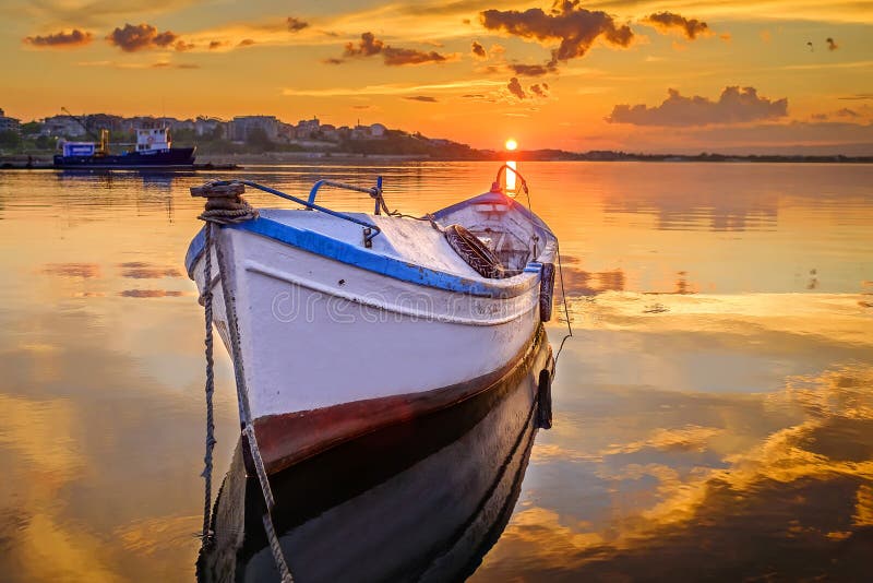 Fishing boat at sea in orange incredibly beautiful sunset 2