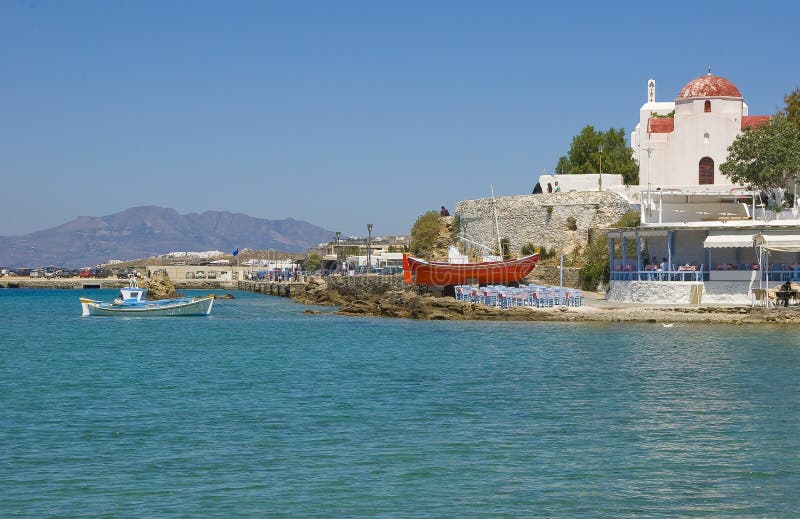 Fishing boat at sea and tavern near the church