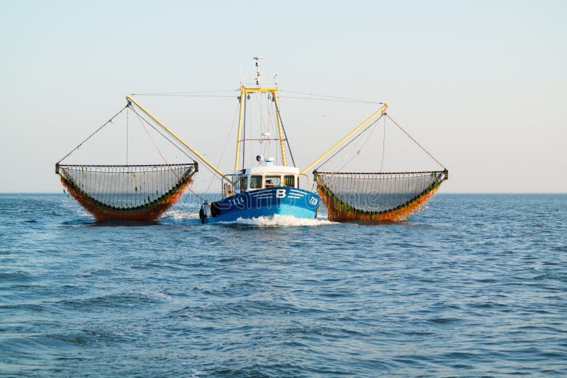 Fishing boat or shrimp trawler fishing on Waddensea, Netherlands