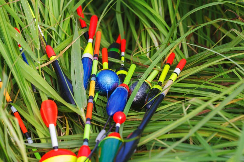 A Fishing Net with Floats in the Foreground. Fishermen Work Behind it