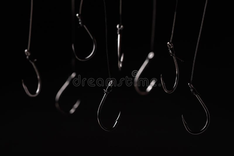 A Fishing Hooks Hanging on a Fishing Line on a Black Background Stock